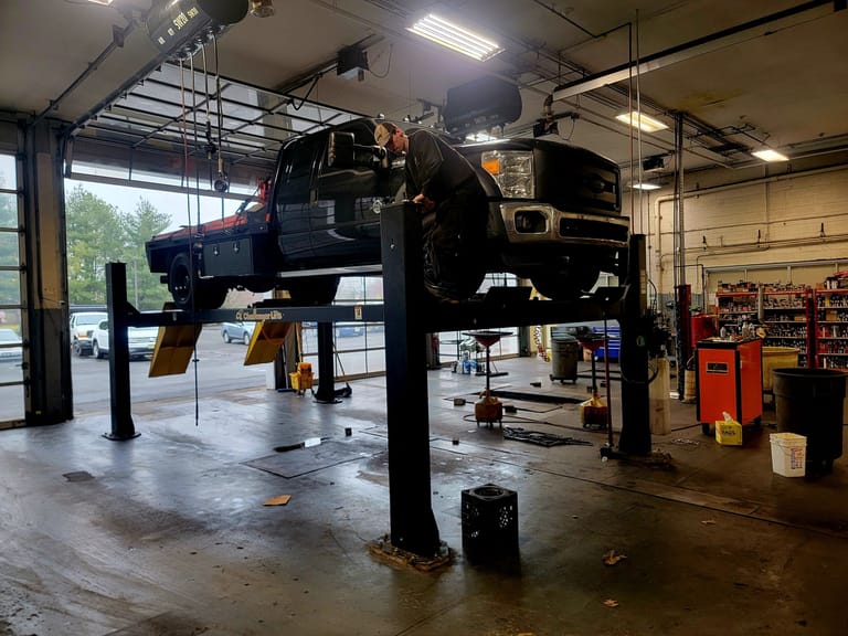 4-post service lift installed in commercial shop